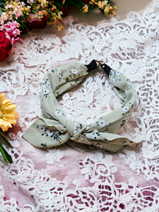 Green headband with small white flowers